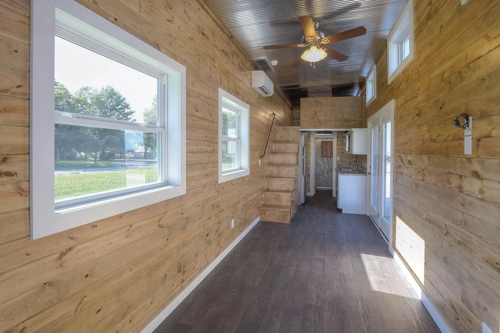 Inside the home proper, there's a main living space which leads to a kitchenette