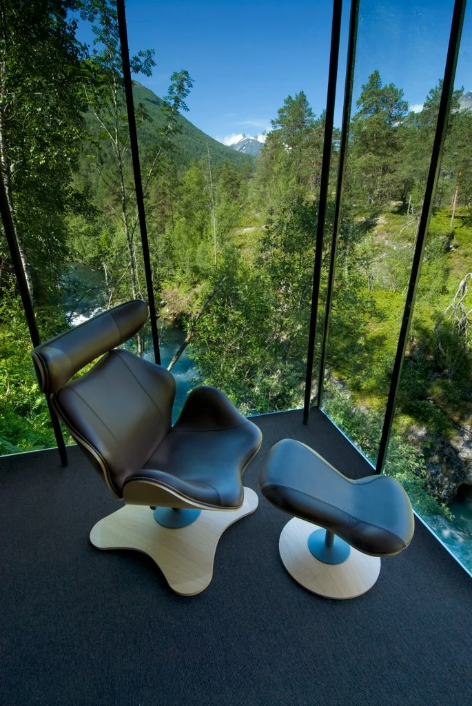 Each cabin features one or two floor-to-ceiling glass feature walls that frame the surrounding nature