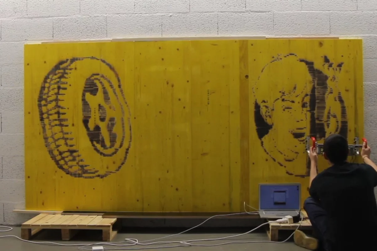 The FireWriter is a handheld printer that burns pictures onto wood with a torch, while an optical sensor keeps track of the image's positioning