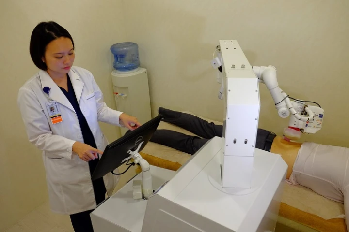 Emma tends to a patient, as instructed by a human user