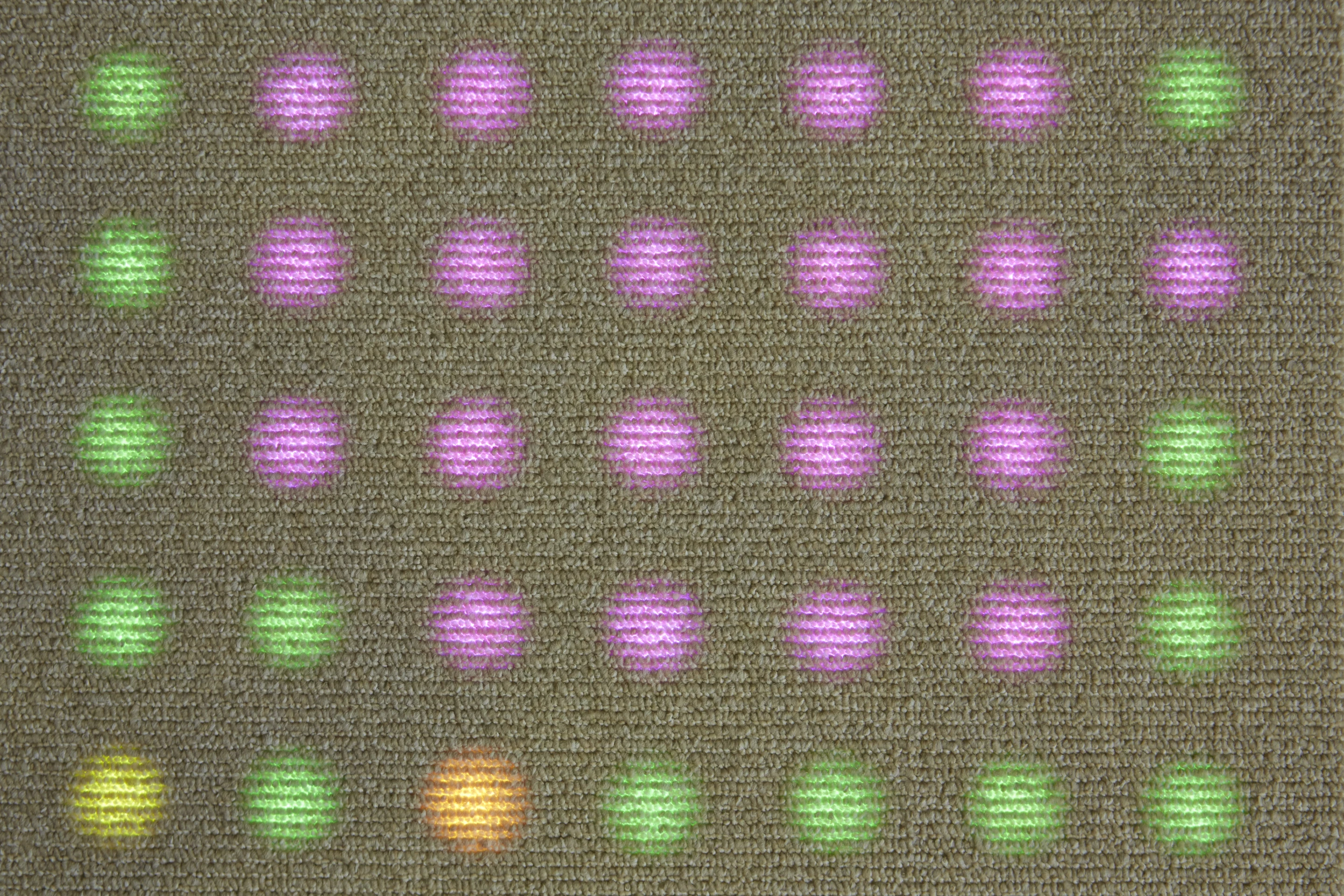 Philips and Desso have only mentioned that it will involve a layer of LEDs beneath a special light transmissive carpet, giving it the appearance of an ordinary carpet until it's lit