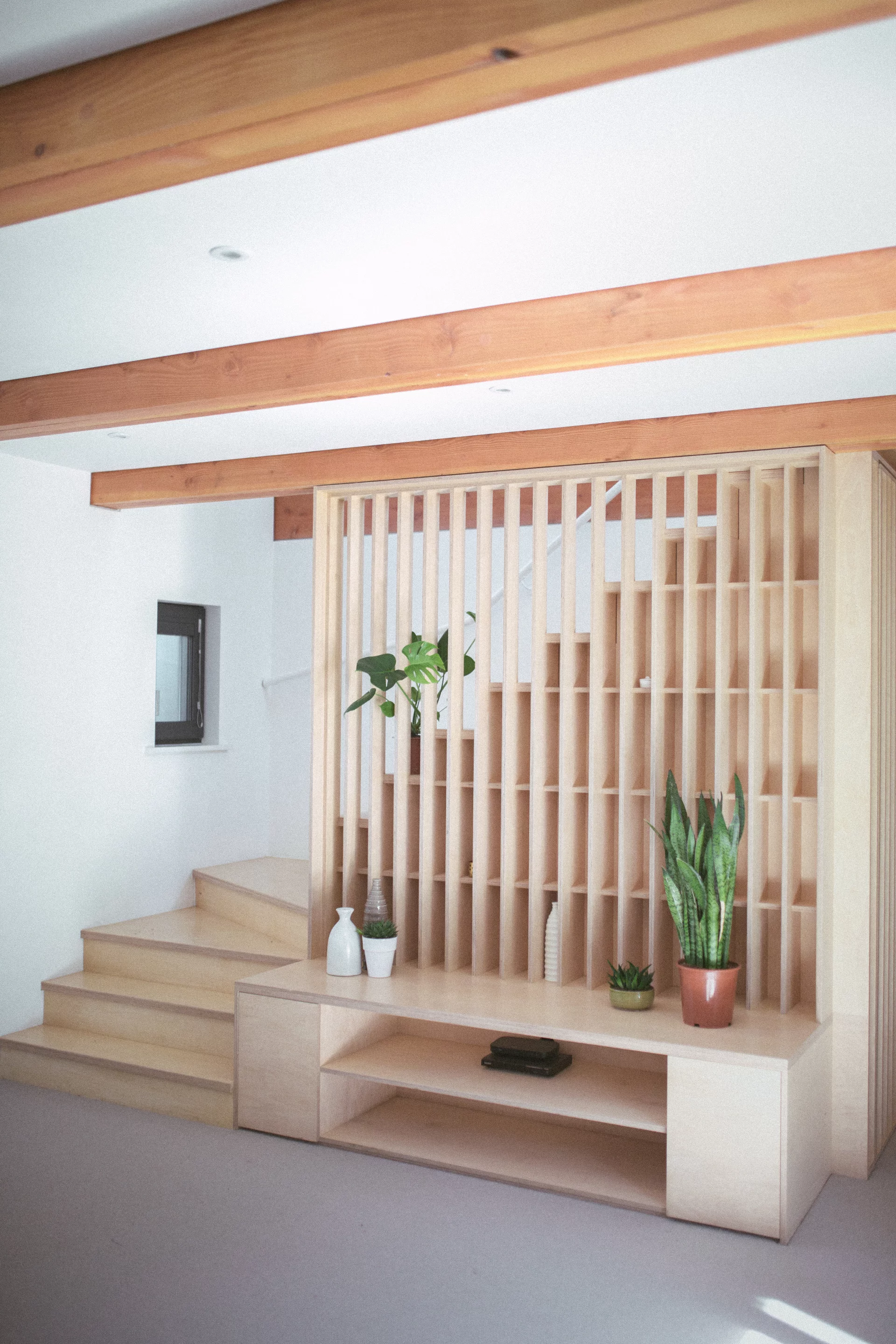 Black Barn's wooden staircase joins the lower private areas with the upper living areas