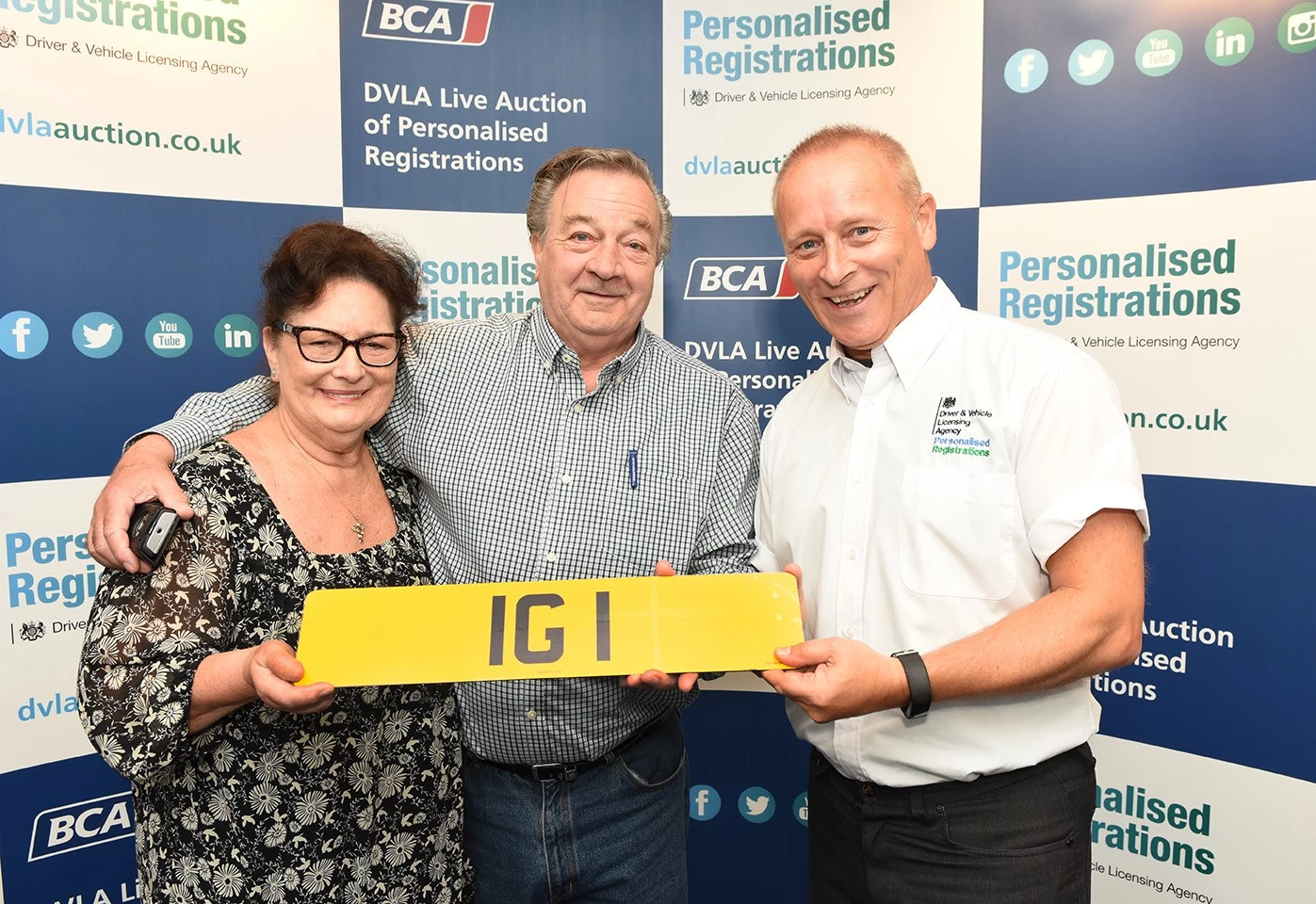 Damian Lawson (right) Head of DVLA Personalised Registrations Sales, with retired businessman Ian Guest and his wife Pamela moments after Guest had successfully secured the personalised registration IG 1 for £222,000, making it the Agency’s third highest-selling in its 30-year history of selling personalised registrations