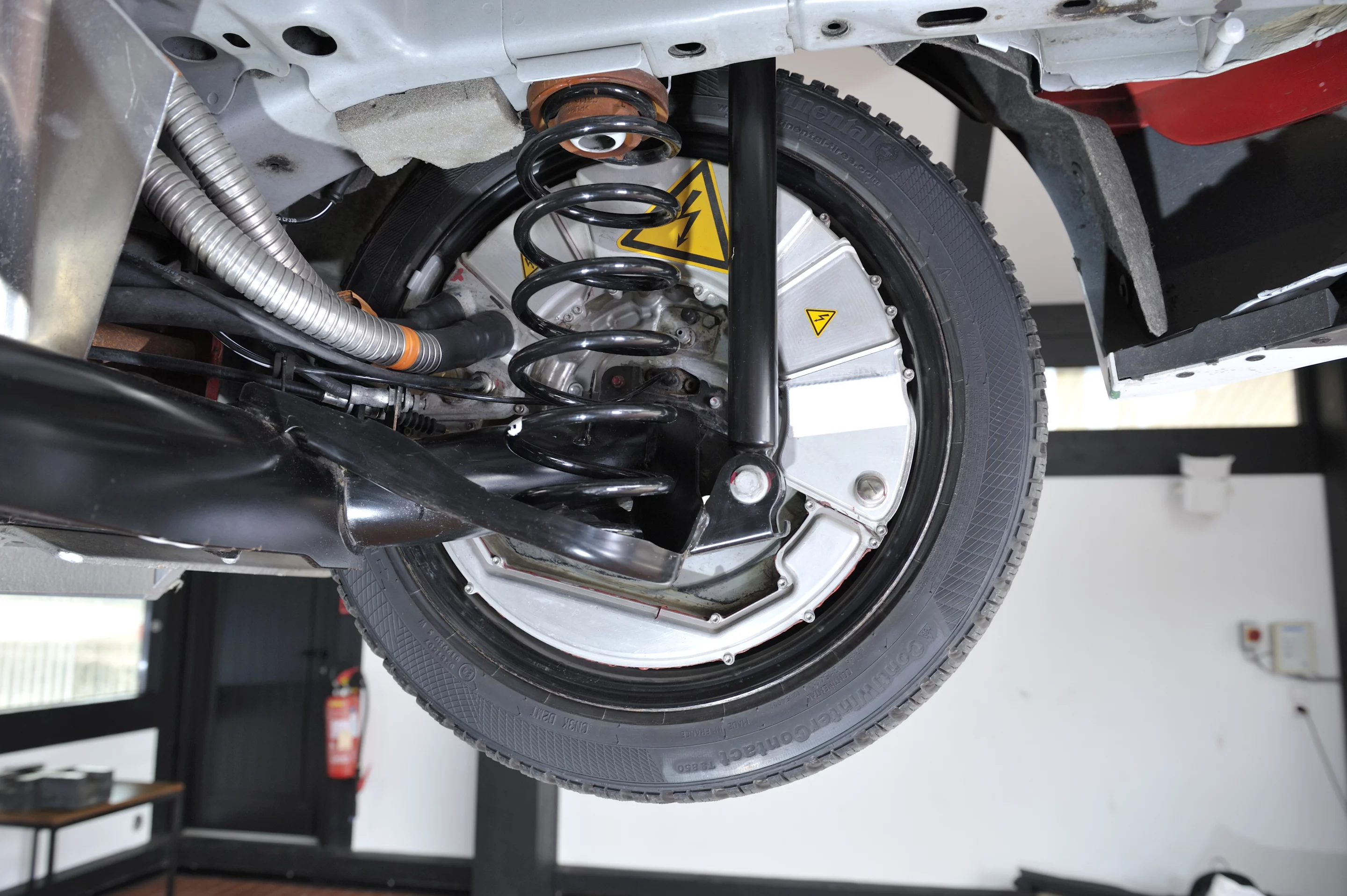 Warning stickers mark the electric hub motors in the rear wheels