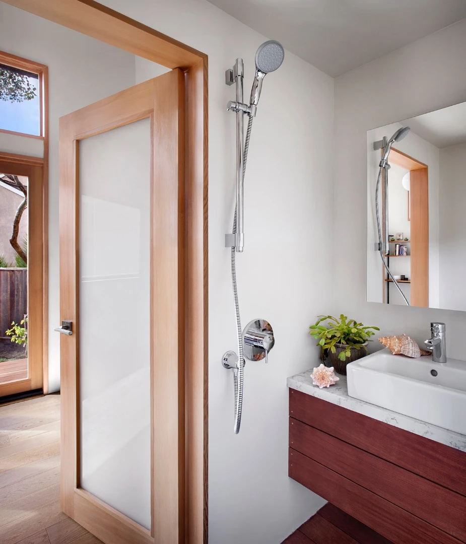 The snug bathroom includes a shower, toilet, and sink