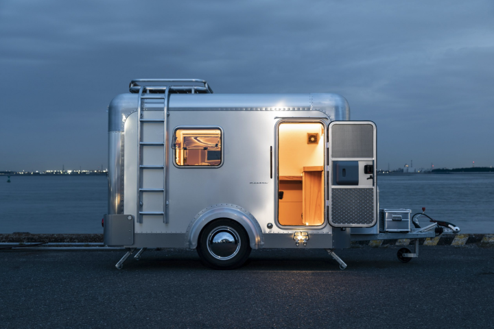 X-Cabin shows its trailer with a side ladder and rooftop cargo basket