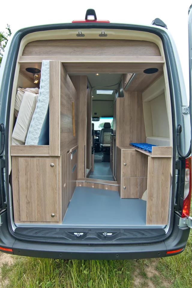 Flip the bed out of the way and you can store boards, bikes or other large gear and cargo