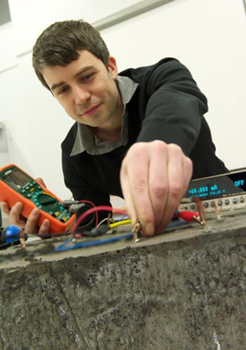 David McGahon applies the smart paint to a test structure