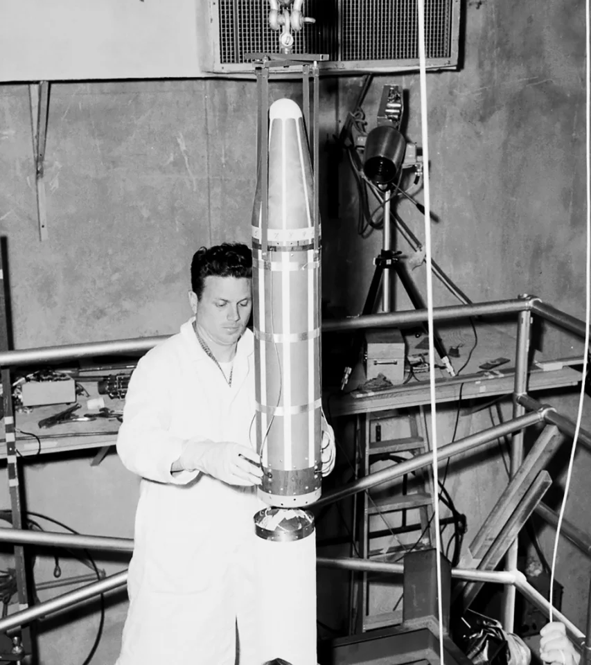 The Explorer 1 satellite pictured being fitted to the fourth stage of the Jupiter-C launch vehicle