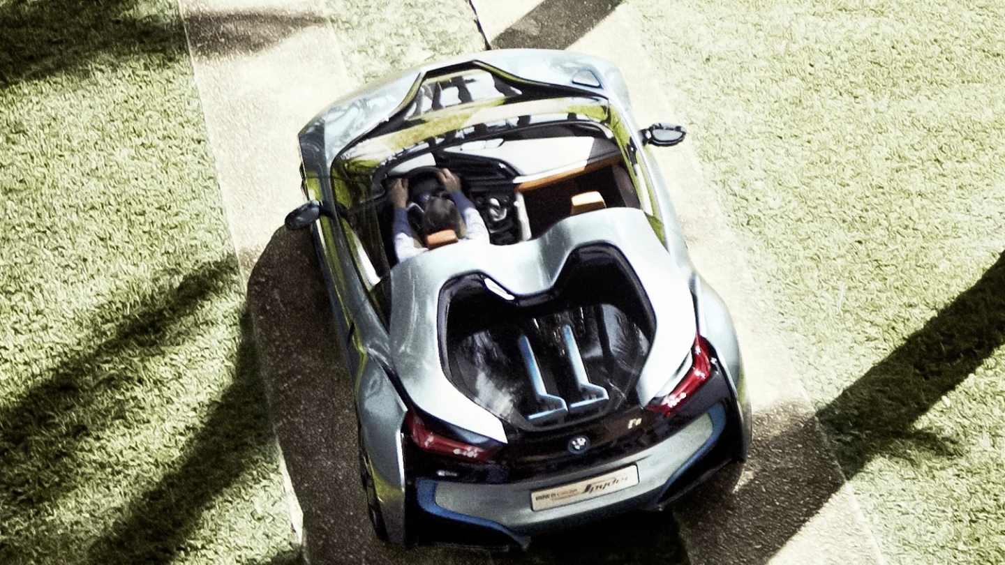 BMW's i8 Spyder with two matching BMW three-wheeled electric kick scooters in the rear
