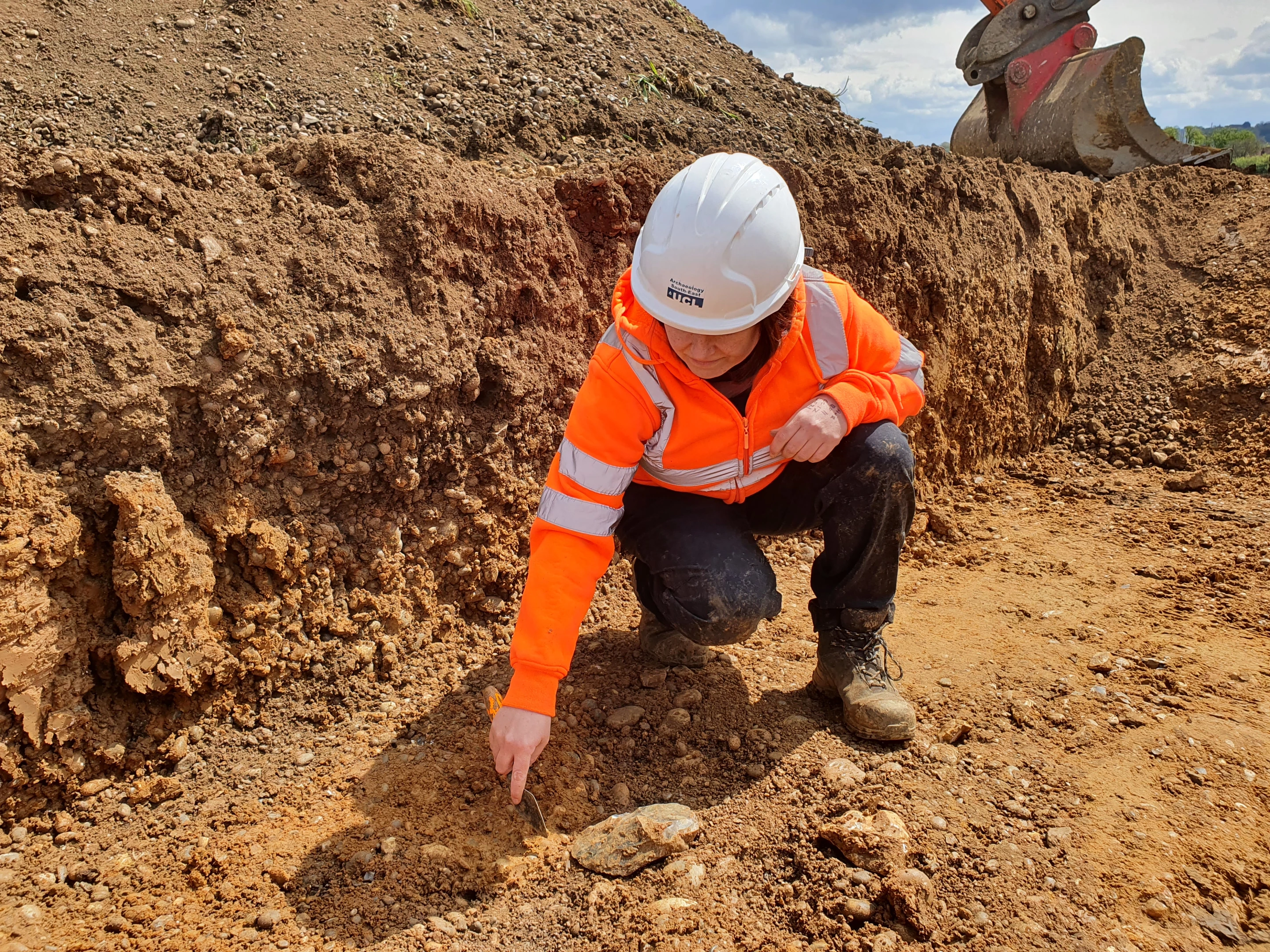 The large flat stone visible in the foreground is one of the hand-axes found at the Manor Farm site by researchers from UCL Archaeology South-East
