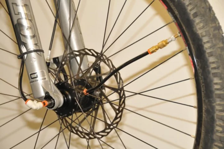 ADAPTRAC is a frame-mounted compressed air system that allows mountain bikers to change the air pressure in their tires, as they're riding