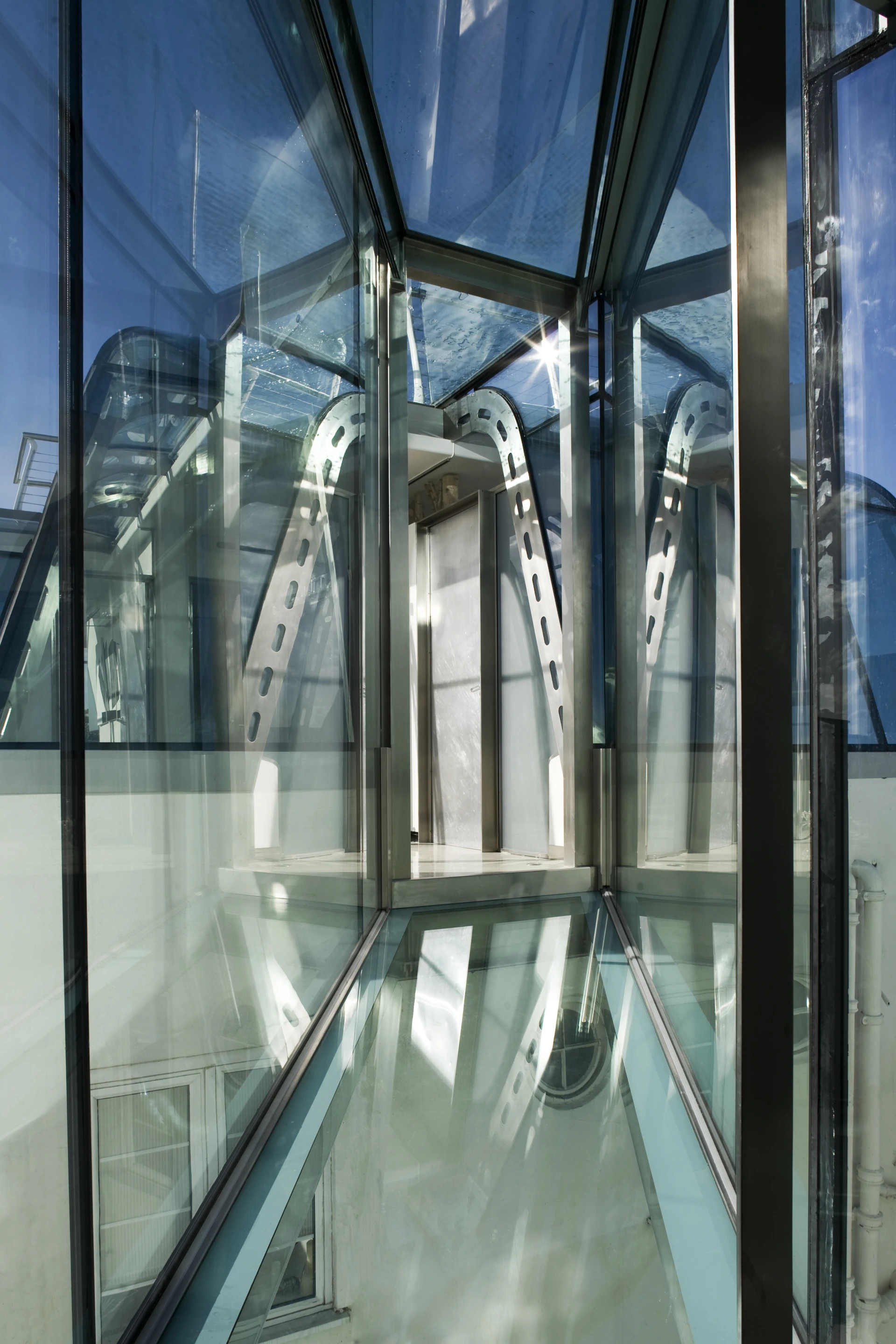 The shape of the home essentially serves to add a Mansard roof to the existing buildings