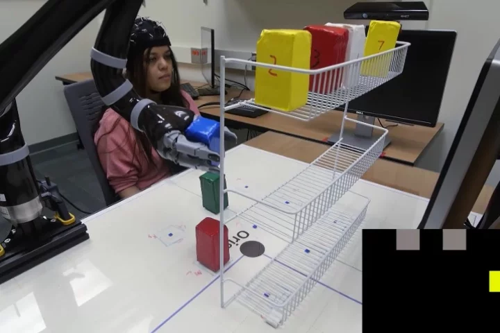 It's all in the mind: the EEG cap lets wearers control the robotic arm with just their thoughts