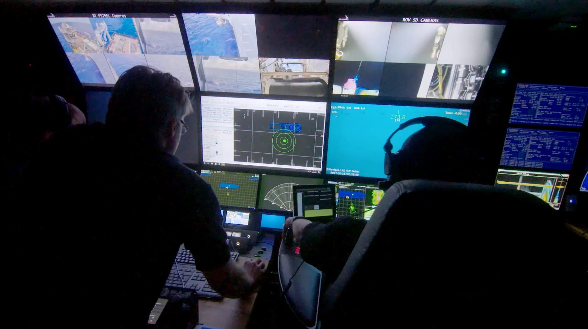 Expedition team members watch as the AUV: Hydroid REMUS 6000 is deployed in search of the USSIndianapolis