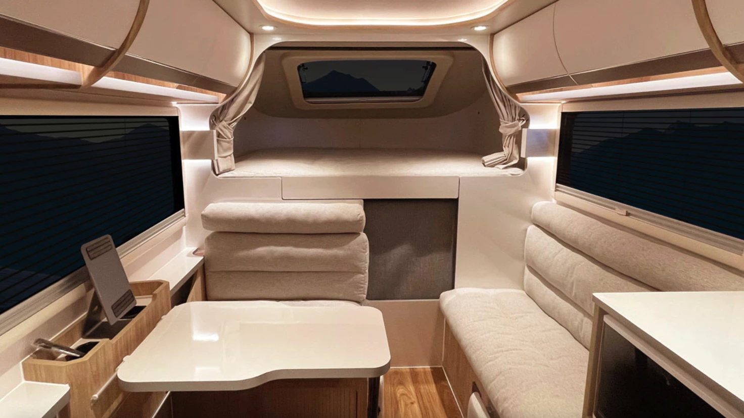 Shown here with lighter furniture trim, the Carryboy interior seating converts into one large L-shaped bed