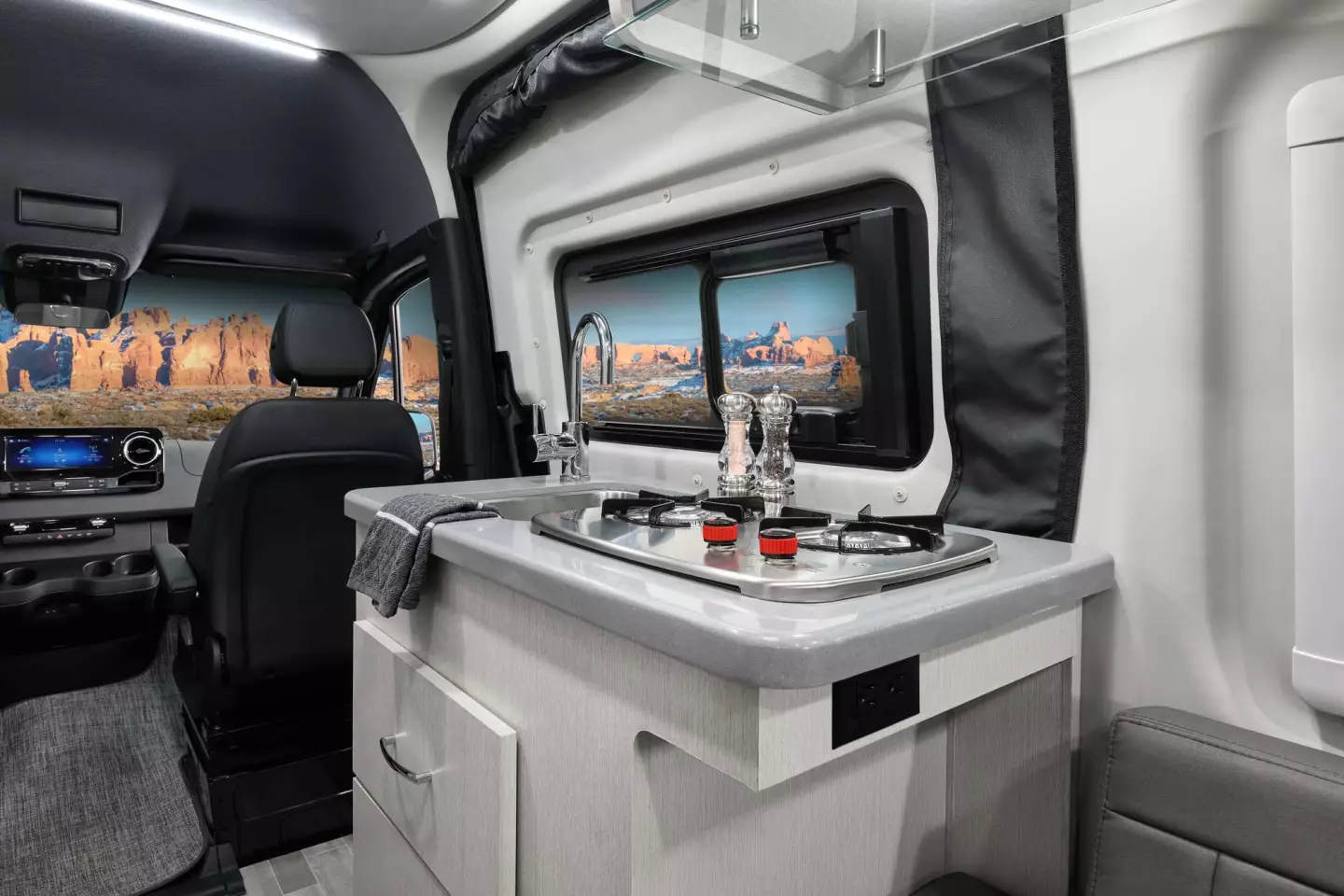 The large convertible lounge/bed necessitates a more compact kitchen, which has a dual-burner gas stove and sink on its main block
