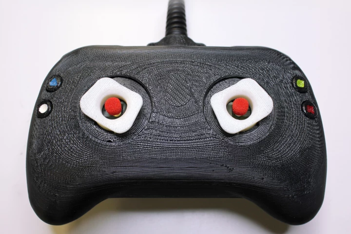 The prototype control pad uses "tactors", independently-moving tactile feedback sticks that stretch the skin of the thumb