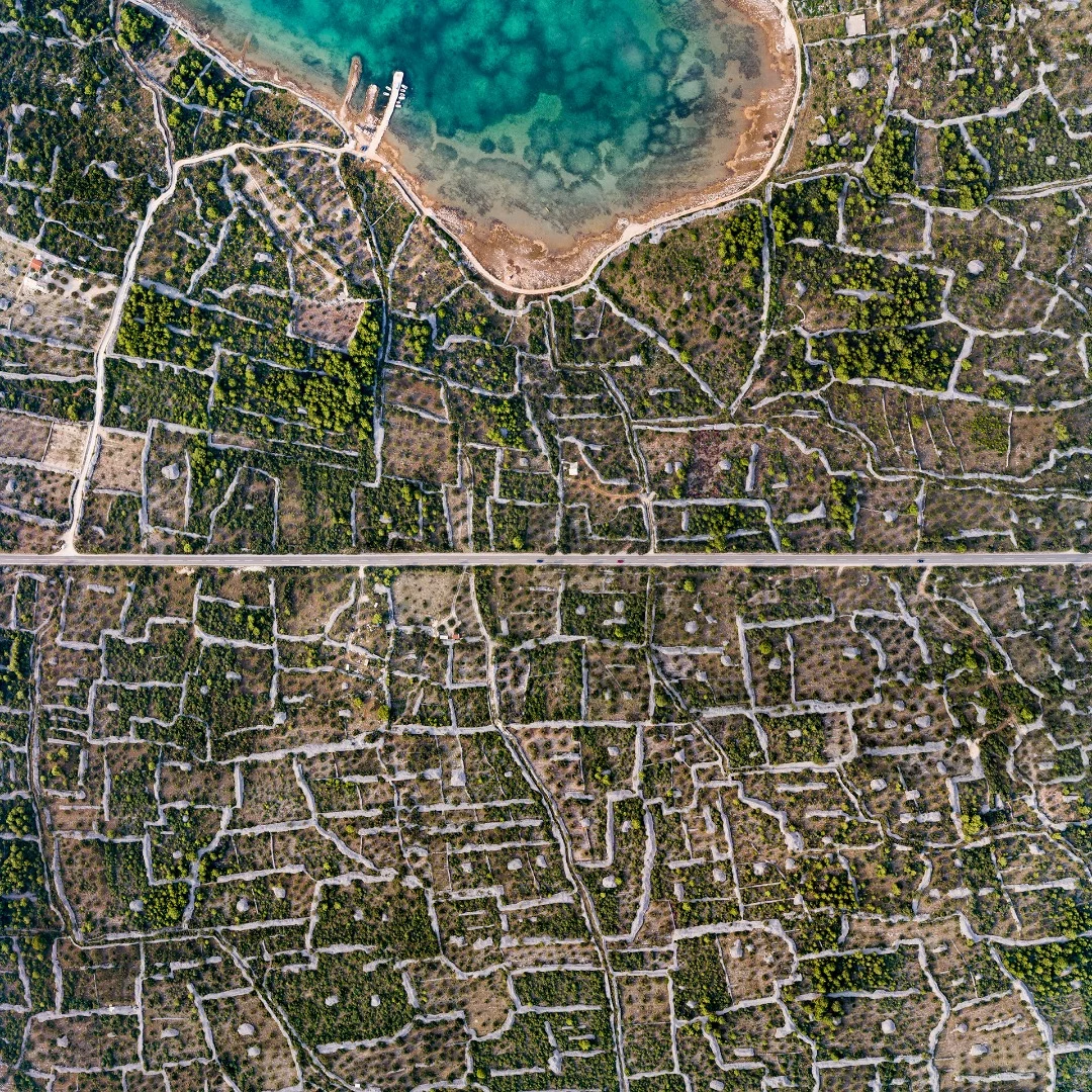Amazing puzzle system of stone walls, built by humans in the last century to keep water on small grape and olive parcels, to hold the soil and to protect plants from the winter winds. Croatia
