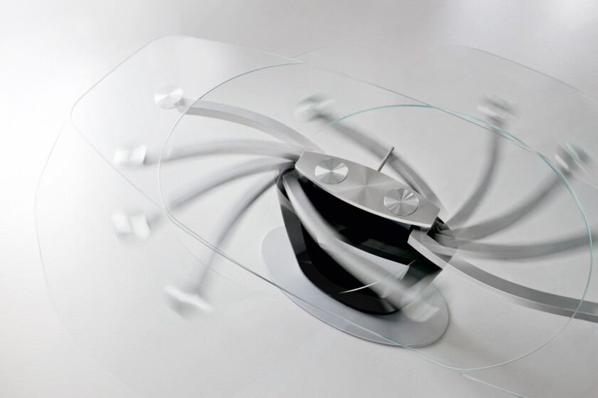 The glass top on the 2011 Calligaris Orbital table reveals its innovative extension mechanism
