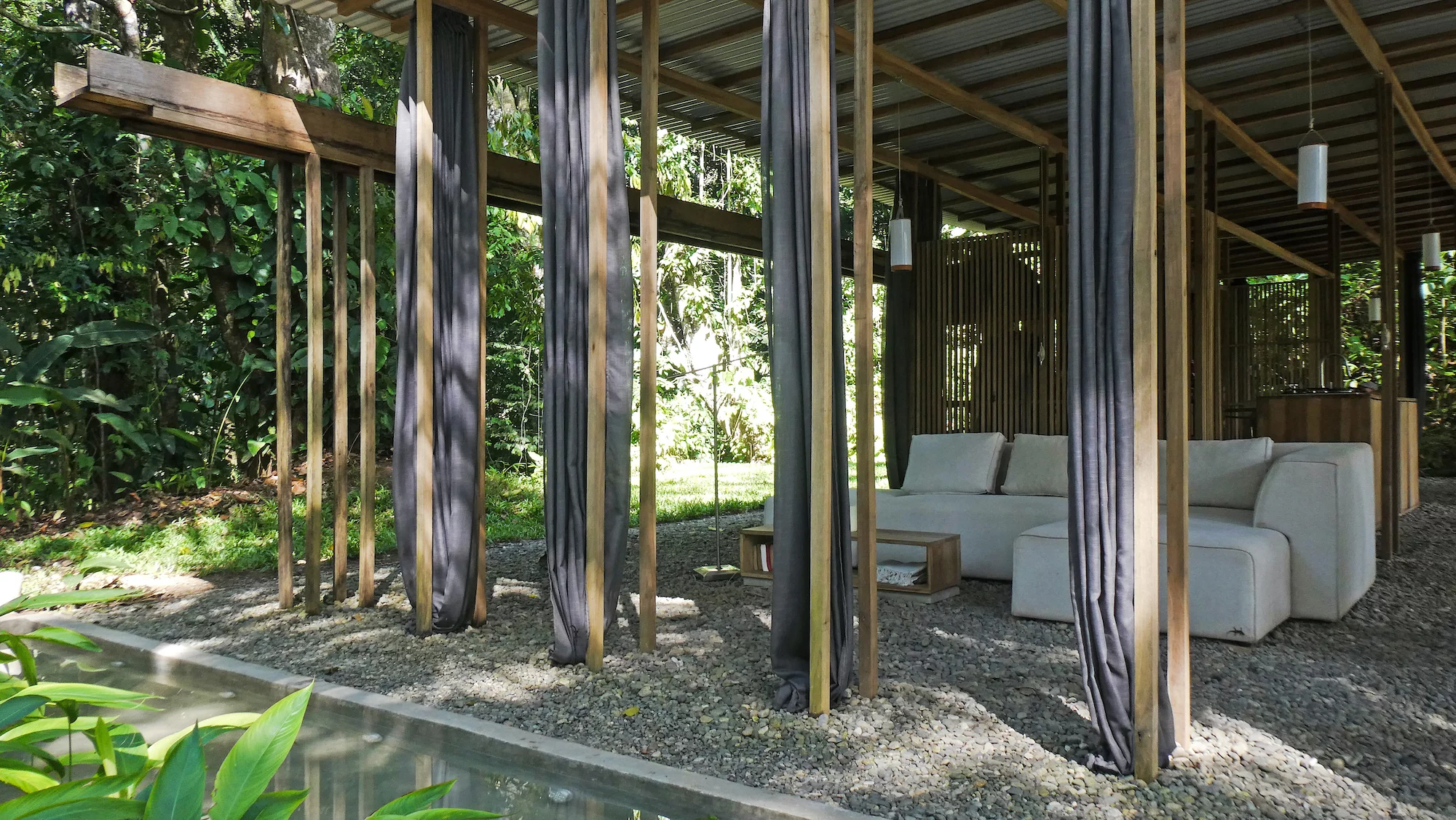 The Open Jungle House channels rainwater from its roof into an underground water storage system and a small pool