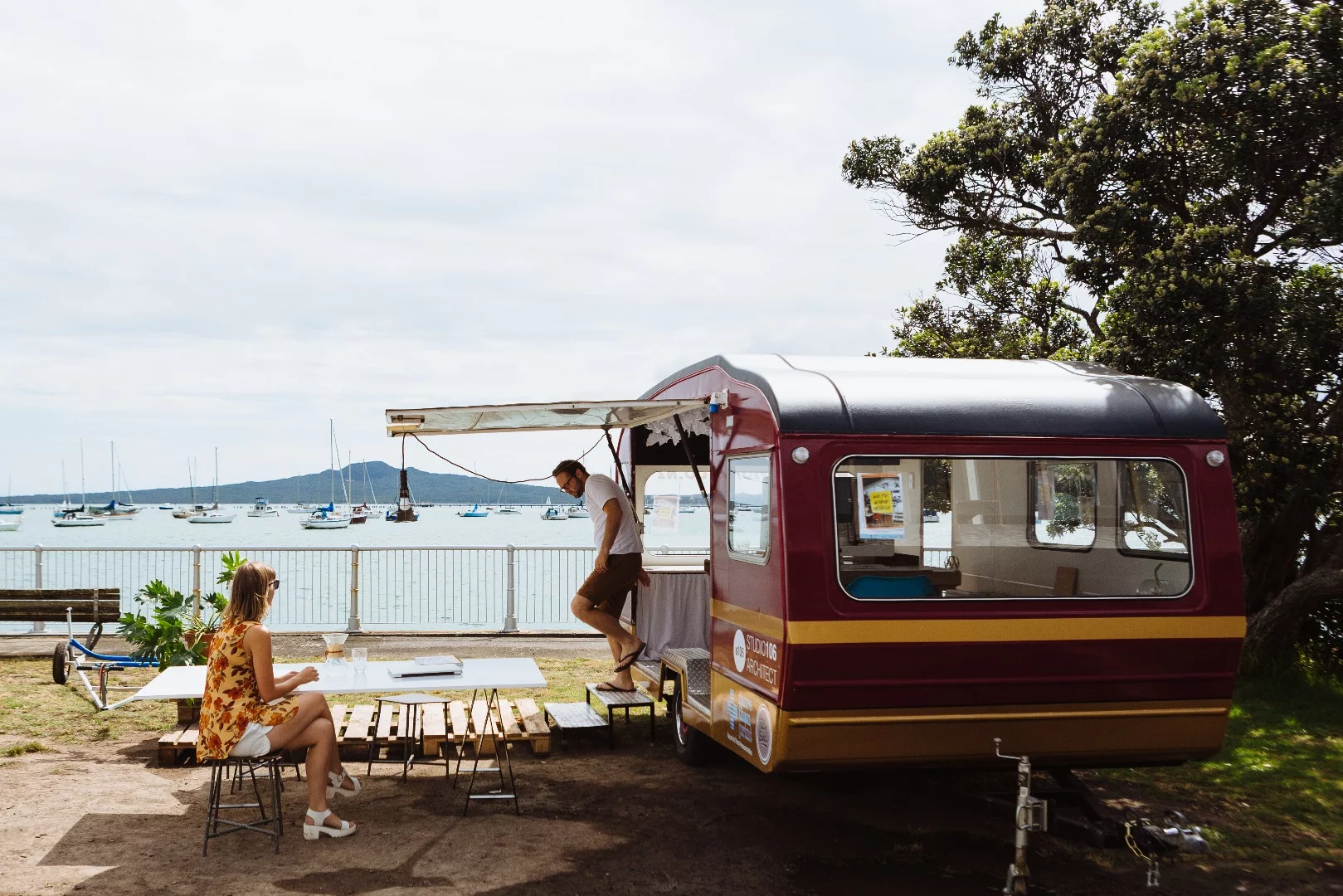 One outdoor zone is made up of a small white-board table and a few stools