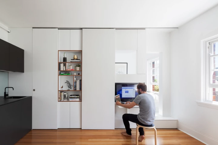 The 27-square meter (290-sq ft) apartment was transformed into a multi-functional home that comfortably accommodates two