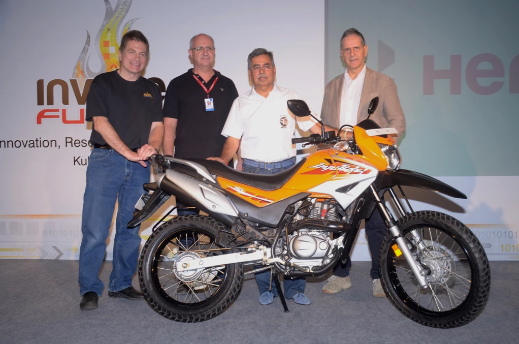 Hero MotoCorp CEO Pawan Munjal and partners pose with a Hero trail bike