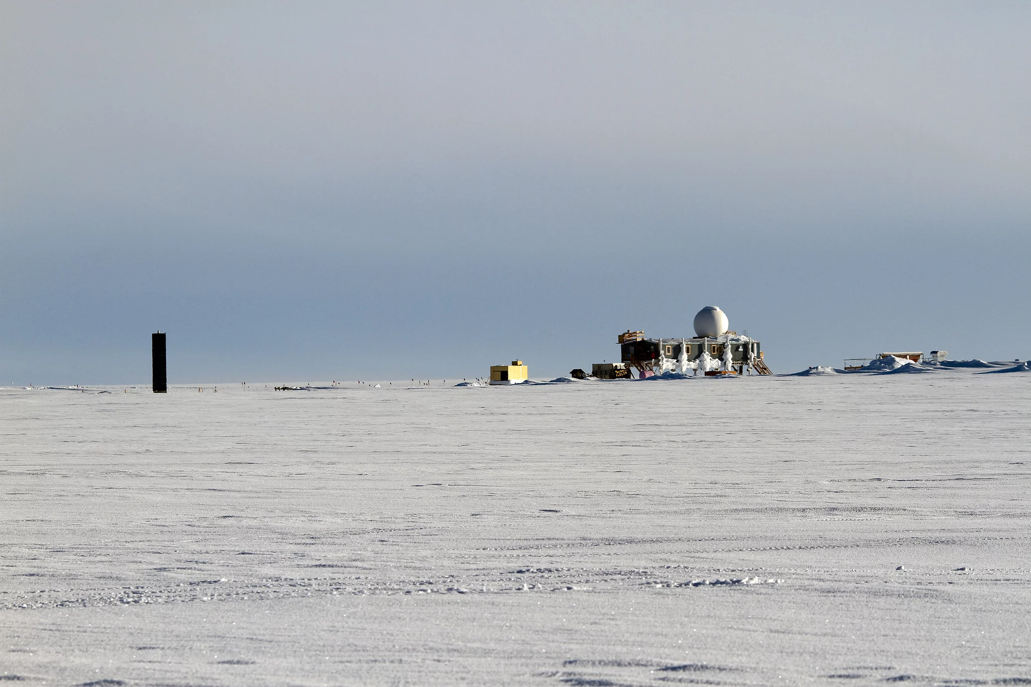 The "Big House" (on stilts to keep it above the accumulating snow) holds the site office at Summit as well as the kitchen and common area (Photo: NASA Goddard/Matt Radcliff)