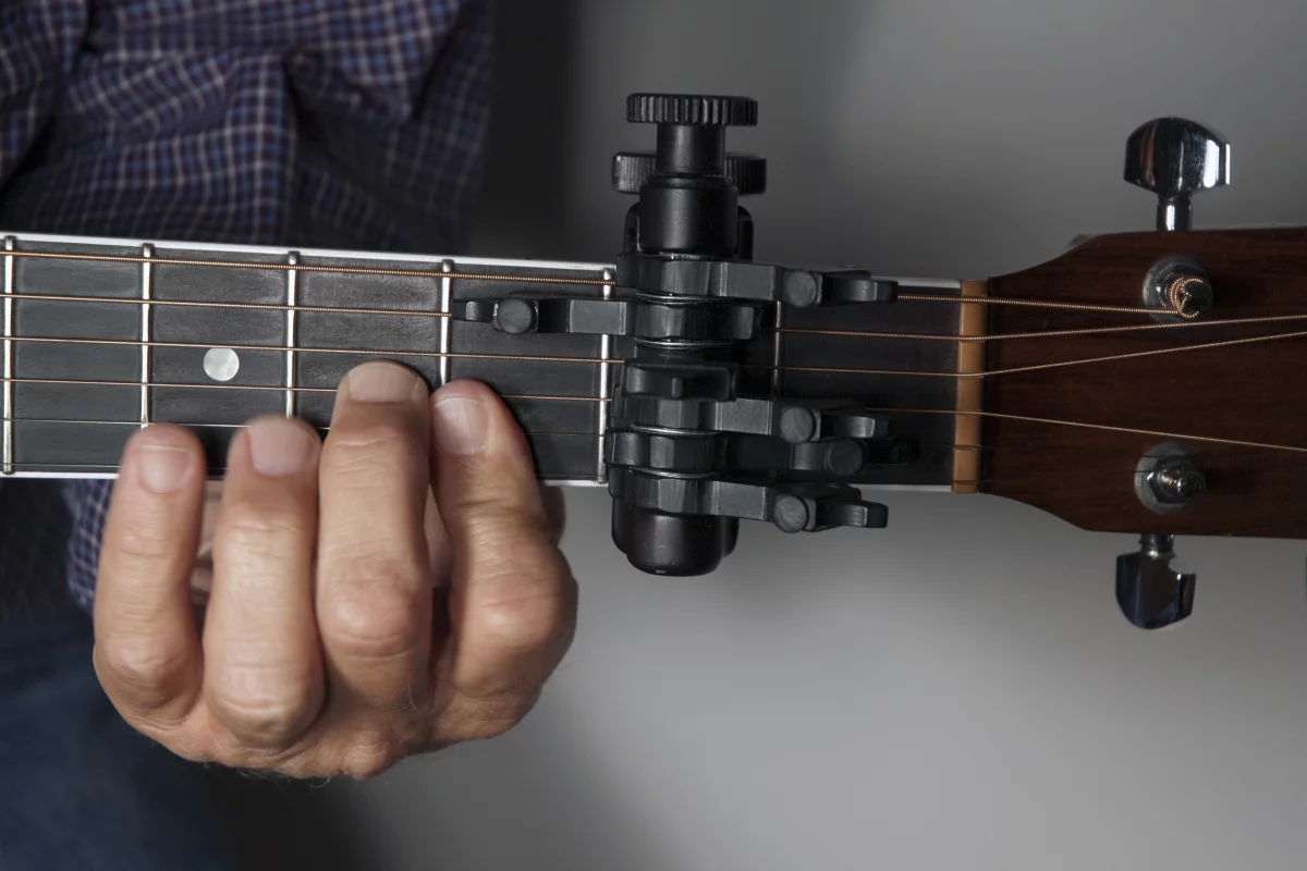 The CapoSonic works like a “clamped-on chord," allowing your guitar to stay in standard tuning