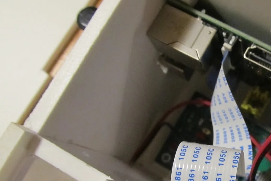 To the rear of the RaspiTrap is an enclosed section housing the Raspberry Pi, a custom PCB, a servo motor and a Pi camera module