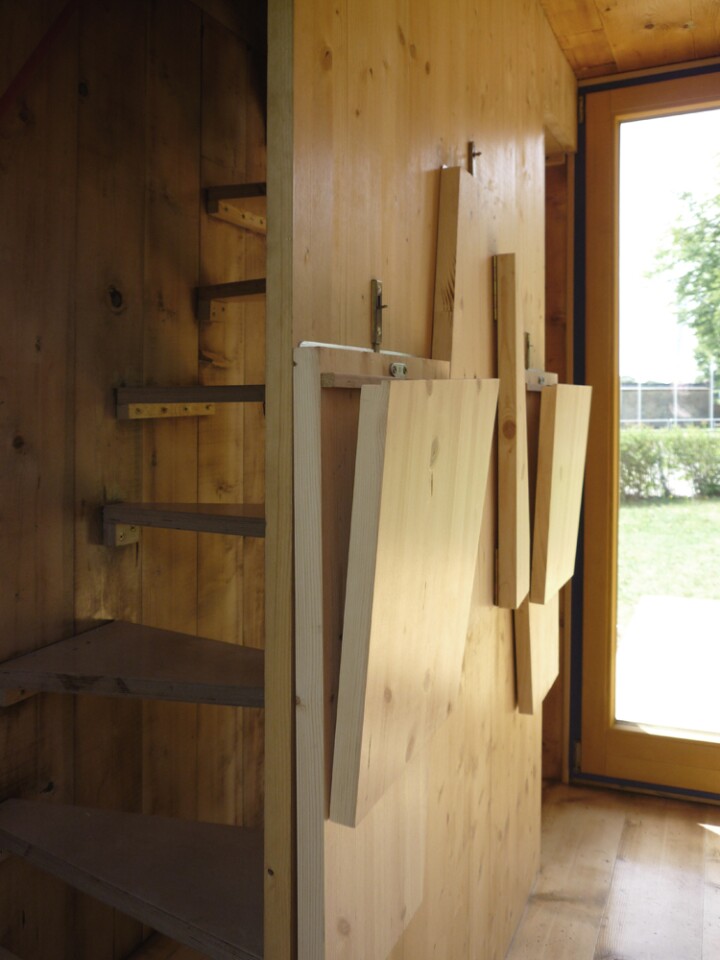 HomeBox includes many wooden inbuilt features such as the kitchen table, chairs, bed, staircases and window shutters