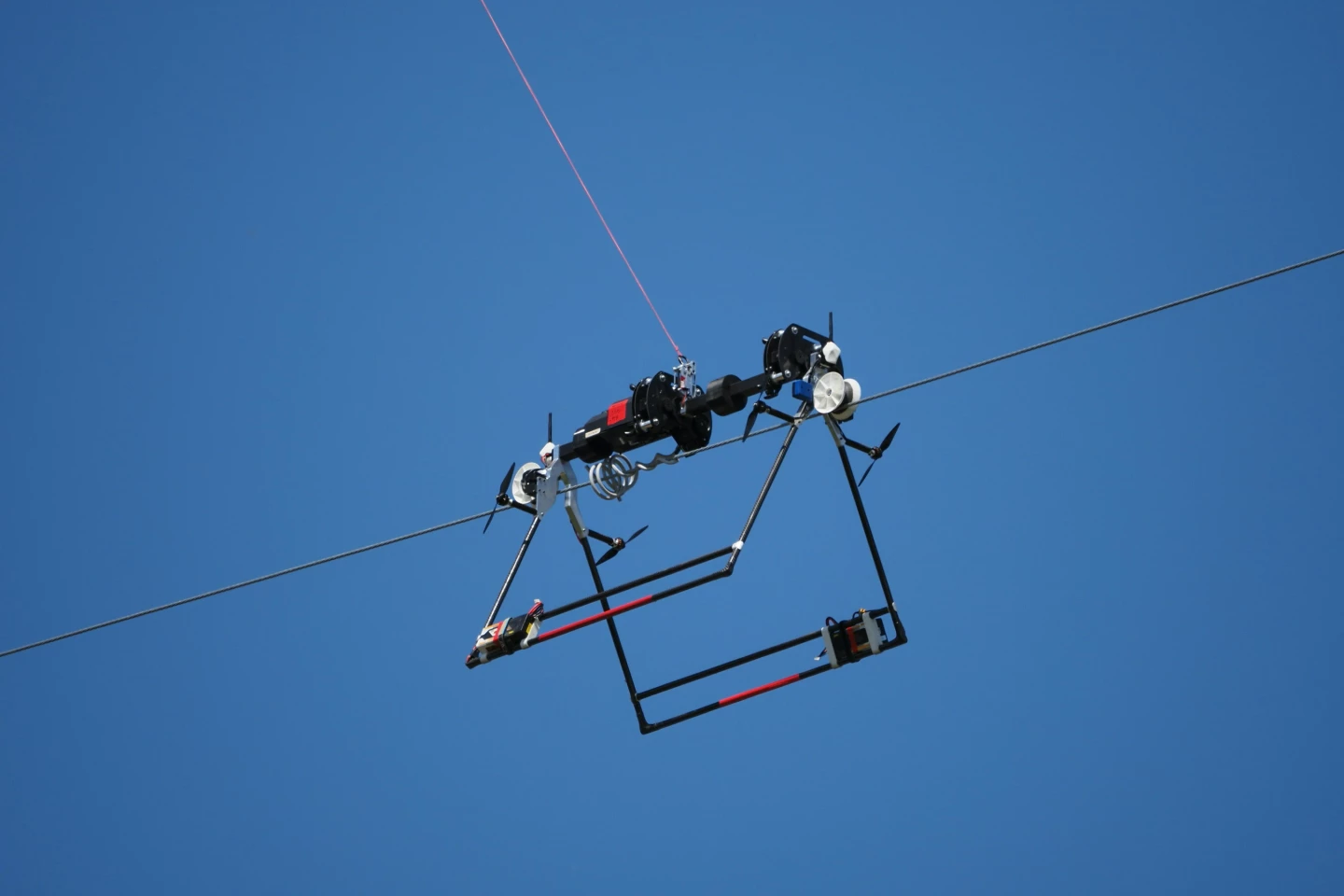 Although the Mini LineFly robot is attached to the drone via a tether, the two devices are independently operated