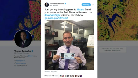 Thomas Zurbuchen, associate administrator of NASA's Science Mission Directorate, poses with his "boarding pass" in 2017