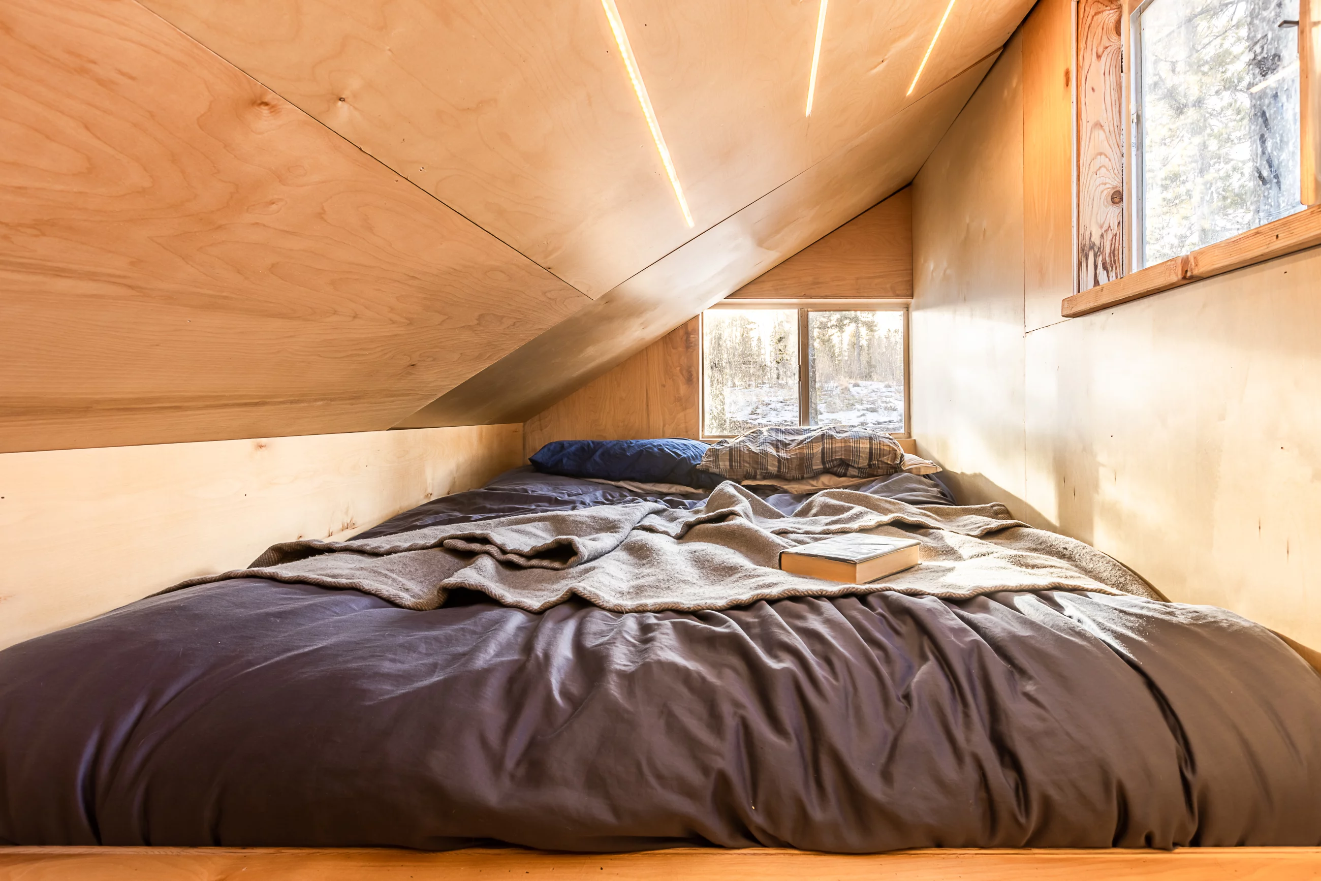 The Magnolia Eco-Cabin's upstairs is taken up by a bedroom with a double bed