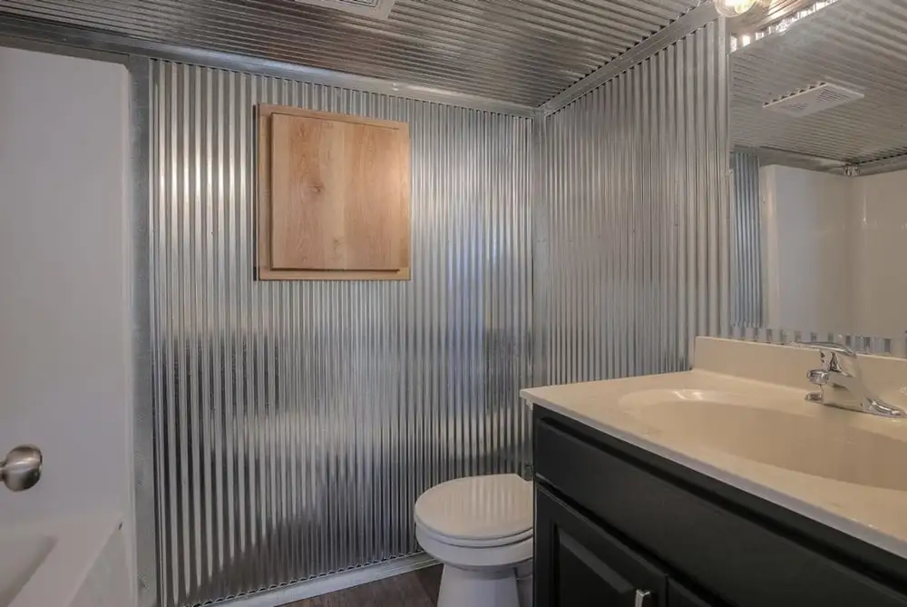 The container home's bathroom features a shower and bathtub