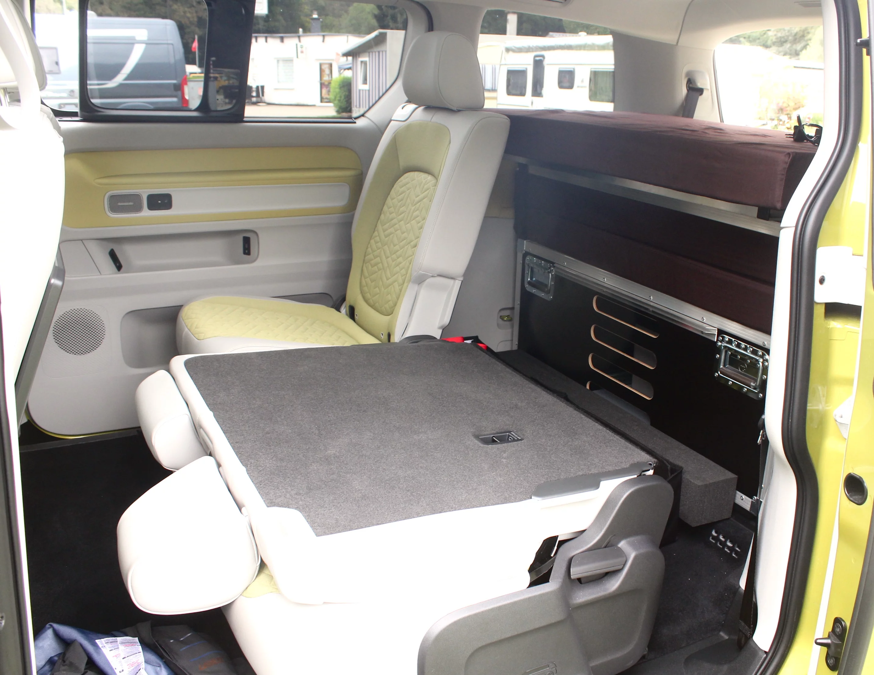 The Ququq BusBox 4 sits completely behind the three second-row seats and can be left in all week if you don't want to load it in and out and don't need third-row seating (notice the foam beam that fell off on the floor in front of the box)