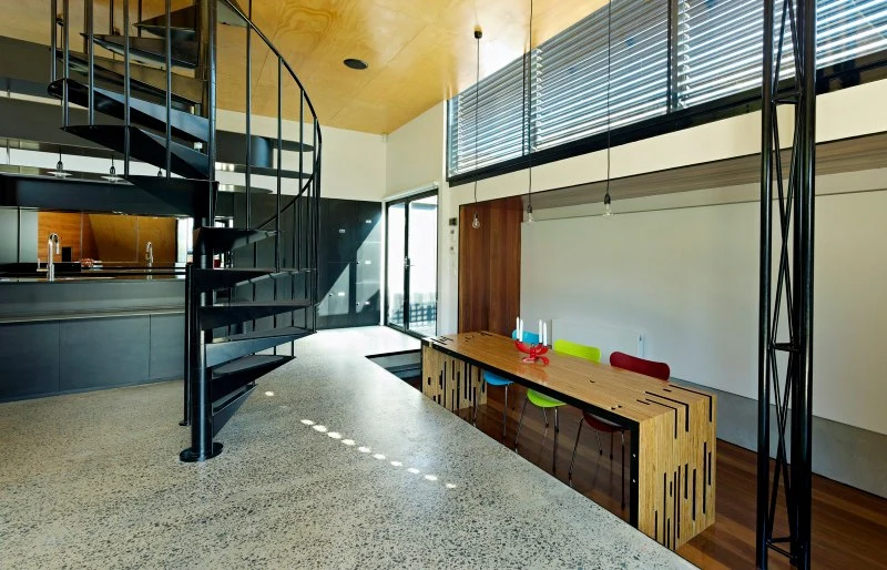 The ground level features a large open living area with modern kitchen and lowered eating area