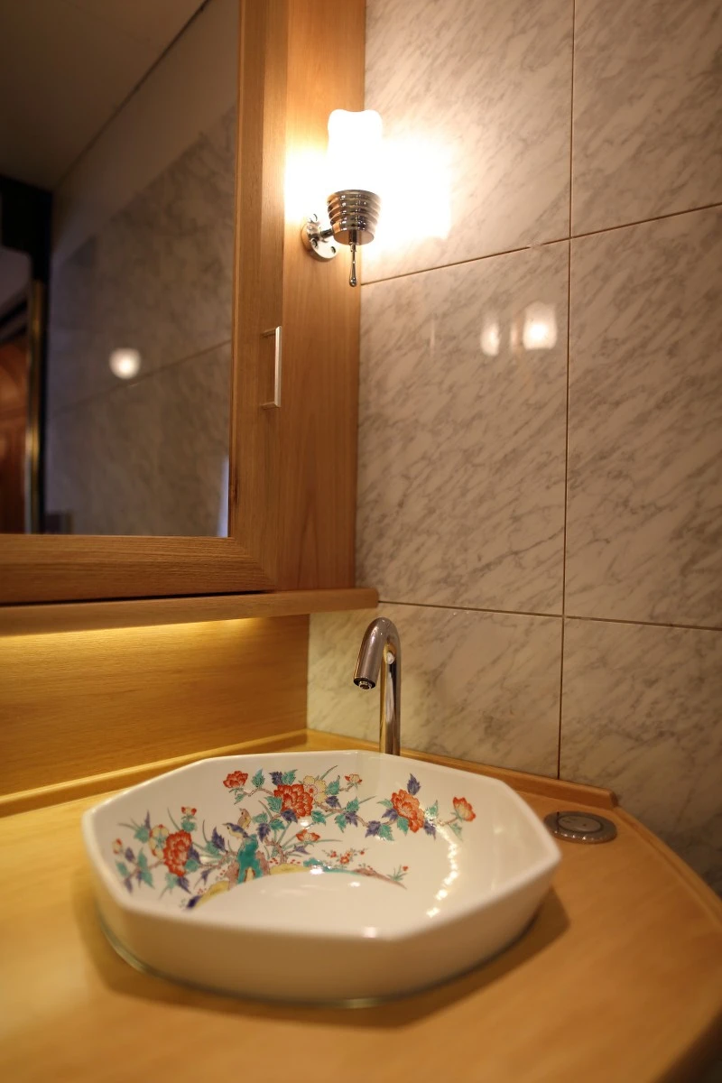 A private ensuite featuring an original antique Japanese porcelain basin