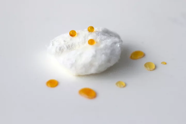 Dyed-water droplets sit on the surface of treated cotton wool (Photo: Oli Usher/UCL)