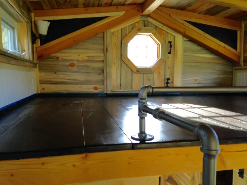 The small sleeping loft and "hobbit door" which leads to the balcony