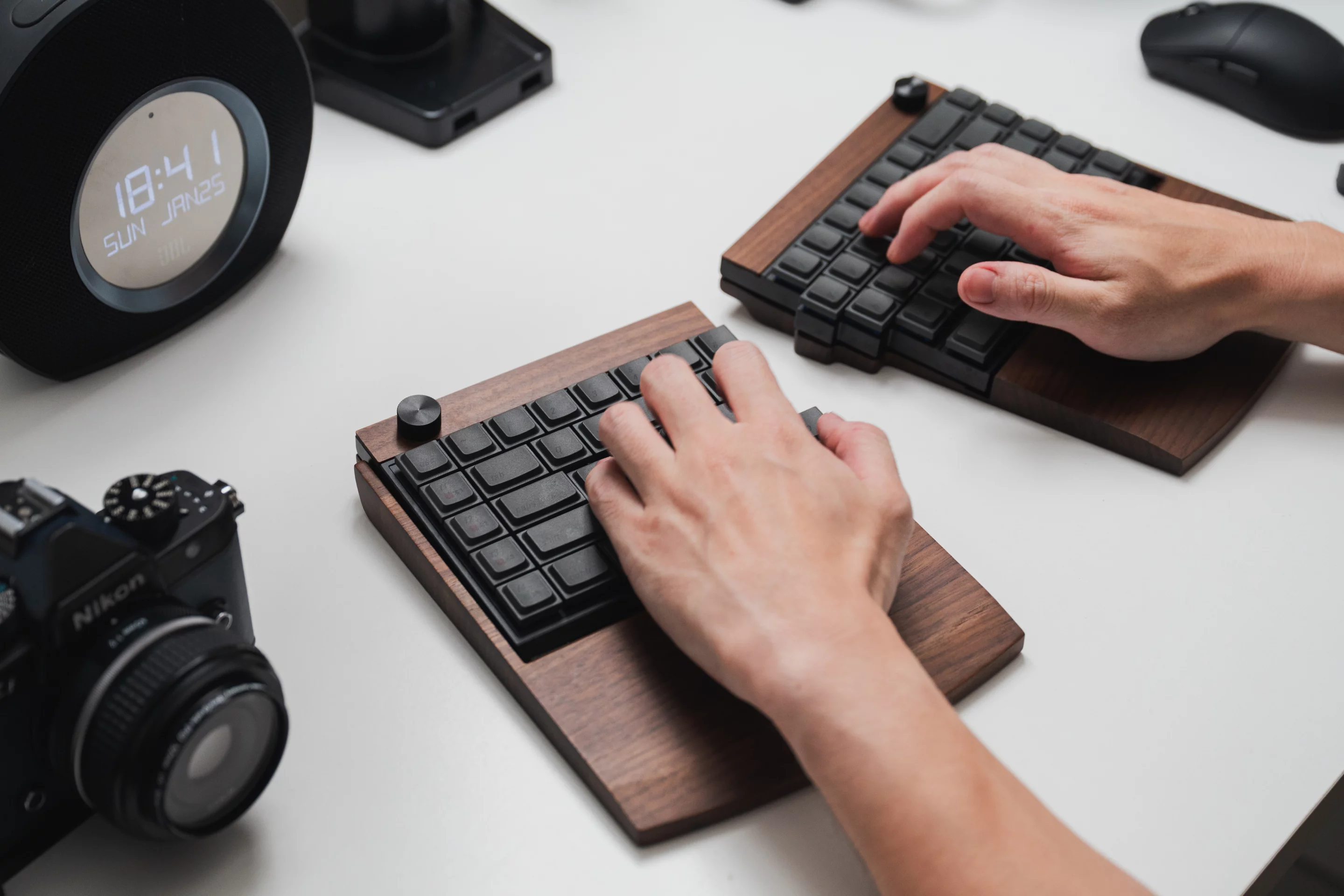 The optional solid wood wrist rest accessory is designed to support the split keyboard layout while adding a more premium desk aesthetic