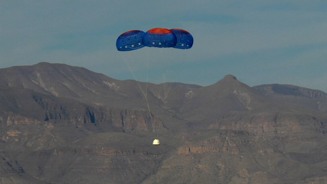 The crew capsule parachutes back to the ground