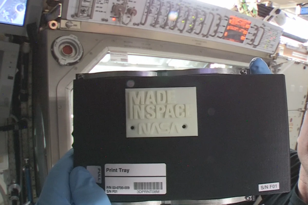 International Space Station Commander Barry “Butch” Wilmore with the first object made in space by 3D printing (Image: NASA)