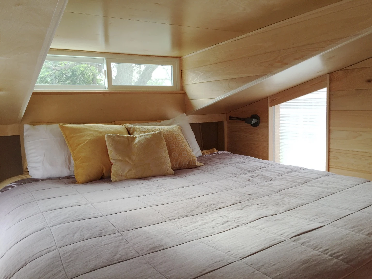 The upstairs sleeping area, very snug but filled with natural daylight