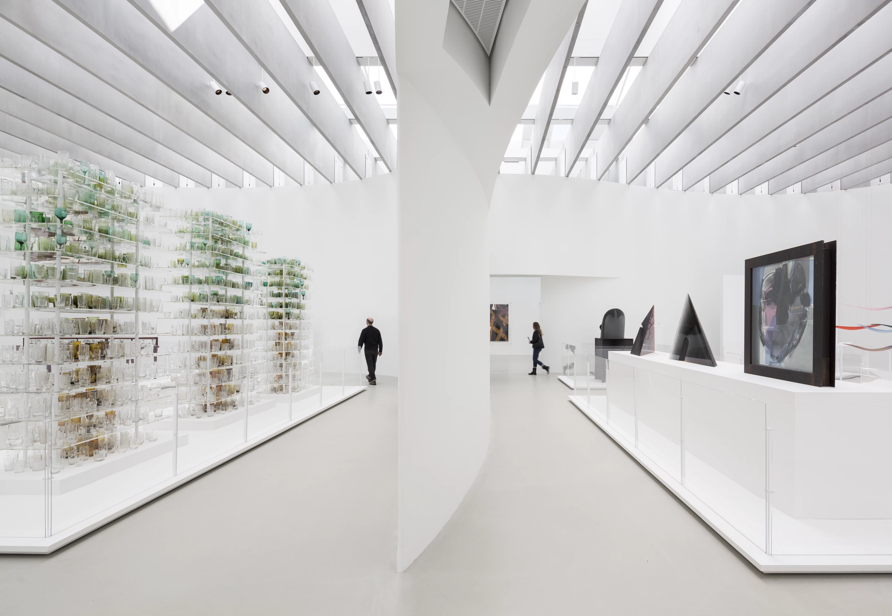 Corning Museum of Glass' new extension features a minimalist white decor and is illuminated by natural light that enters through insulated skylights and fritted windows