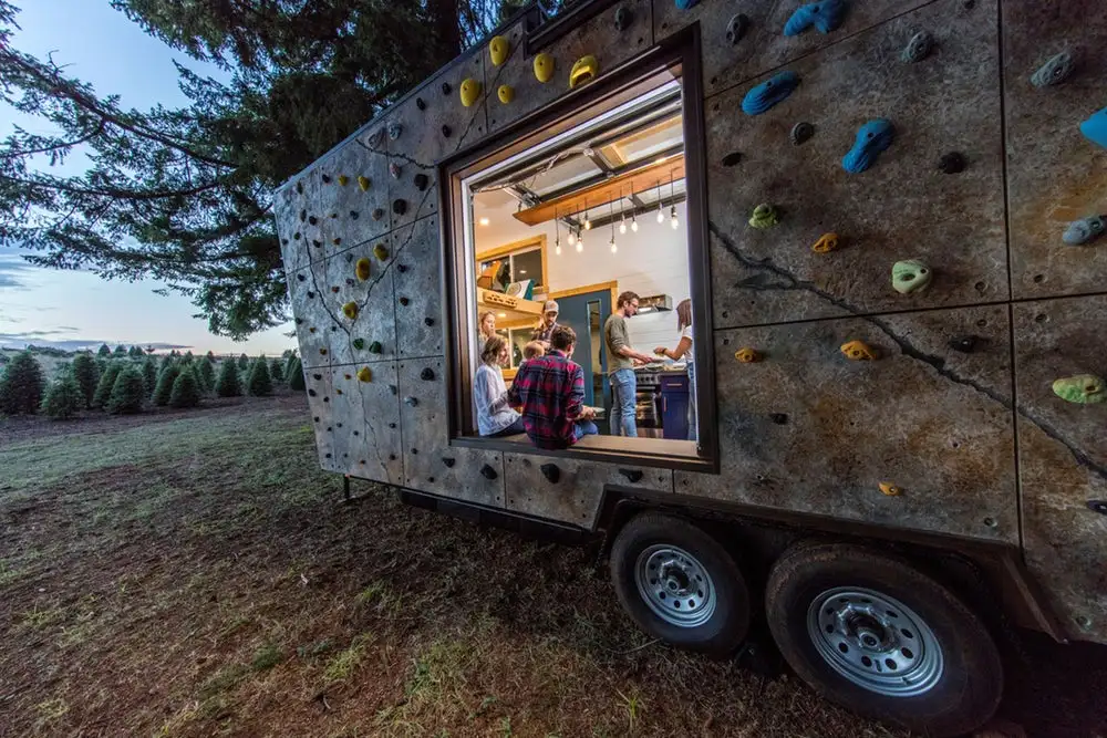 The Tiny Adventure Home features a rock climbing wall on its exterior