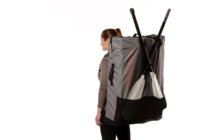 The Oru Bay+ with split paddle and backpack (both sold separately) ready to hike to the water