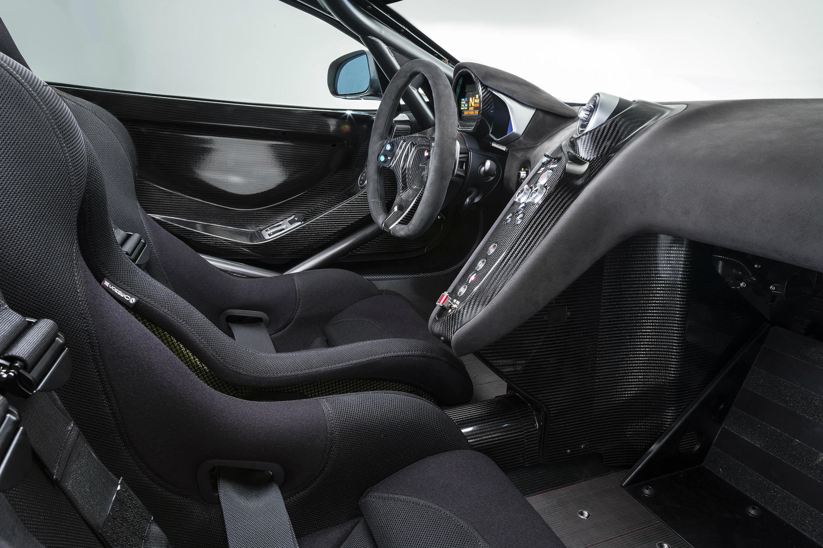 To enhance safety an FIA approved rollcage and carbon fiber HANS-approved racing seats, featuring six-point racing harness for the driver have been built into the snug new cockpit