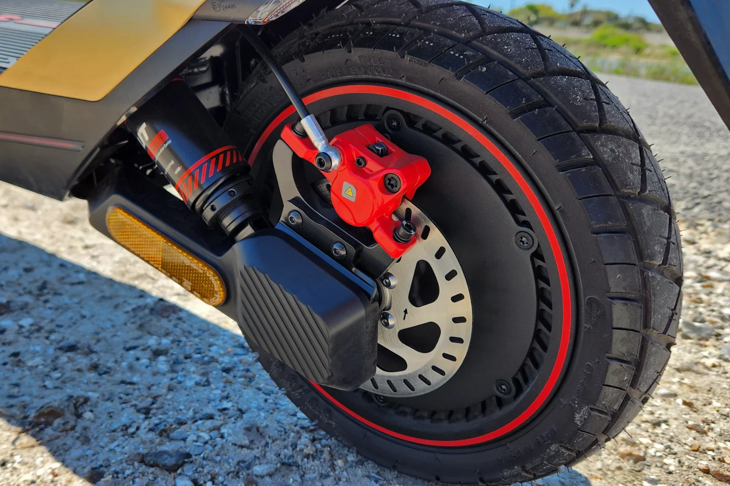 Here's an up-close of that meaty 12-inch rear tire (tubeless and self-sealing), hub motor, and radially-mounted, single-piston floating caliper. Red? Yes. Brembo? No